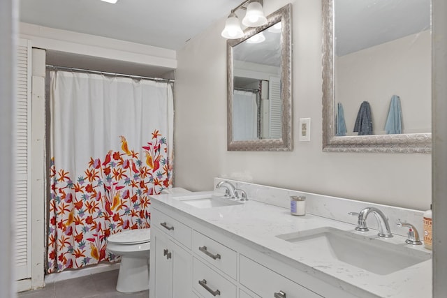 bathroom with toilet, tile patterned flooring, and vanity