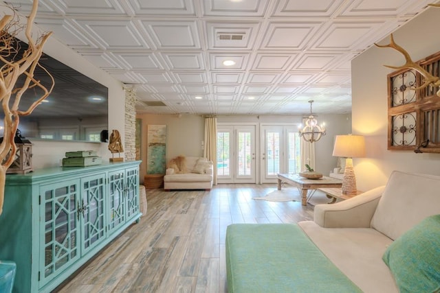  - living room with an ornate ceiling, light wood finished floors, a chandelier, and recessed lighting