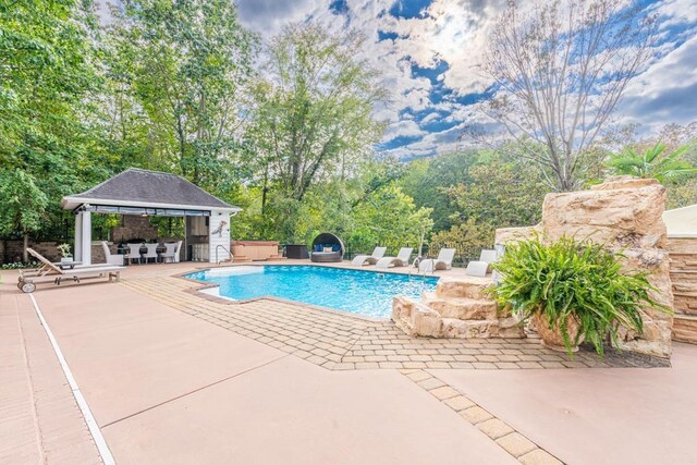  - view of pool featuring a gazebo, a patio, and fence