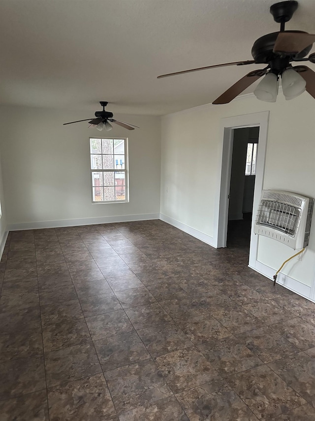 unfurnished room with heating unit and ceiling fan