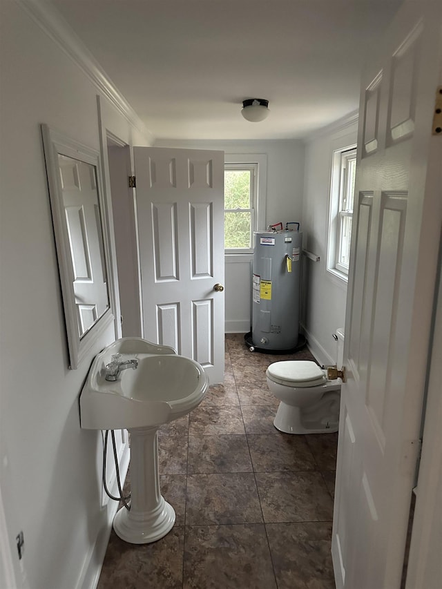 bathroom with electric water heater, crown molding, tile patterned flooring, and toilet