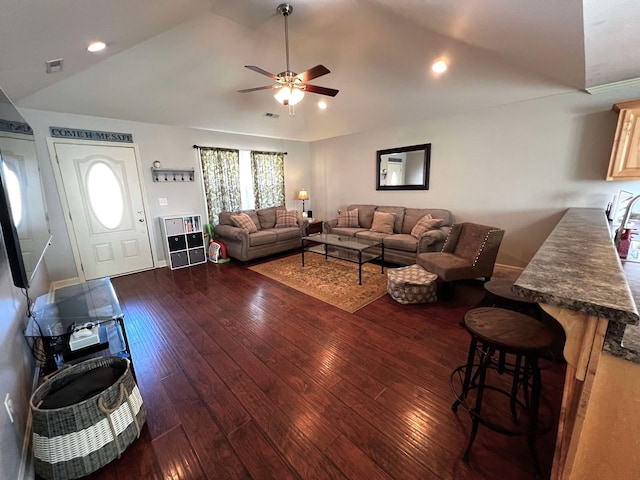 living room featuring lofted ceiling, dark wood-type flooring, and ceiling fan