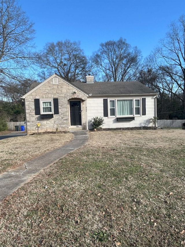 single story home featuring a front lawn