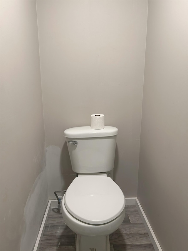 bathroom with toilet and hardwood / wood-style floors