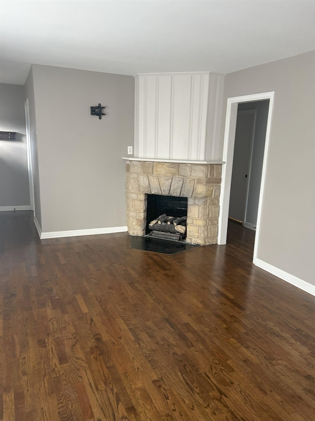 unfurnished living room with dark hardwood / wood-style flooring and a fireplace