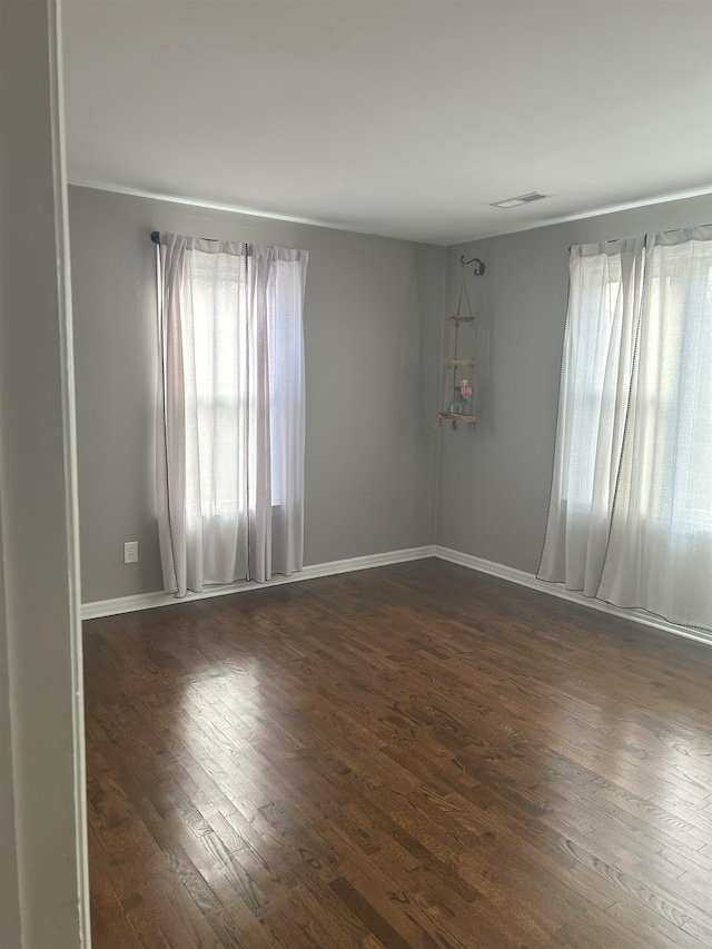 empty room with dark hardwood / wood-style floors