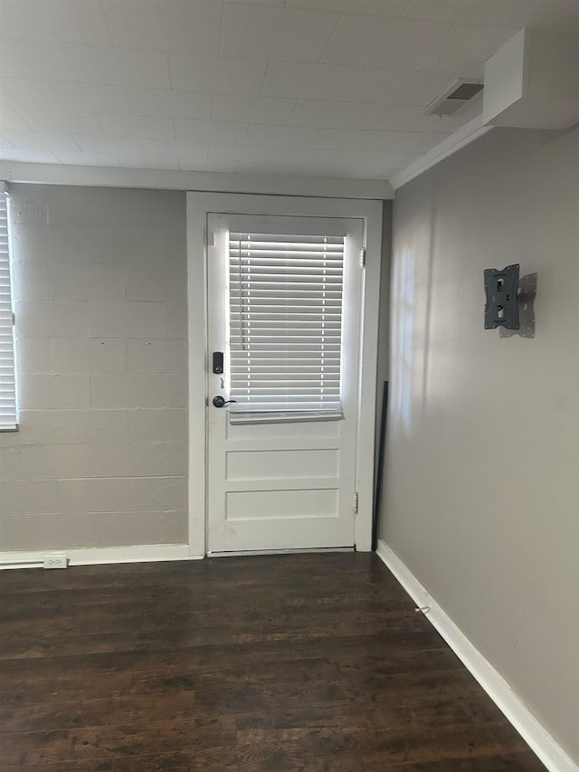 entryway with ornamental molding and dark hardwood / wood-style floors