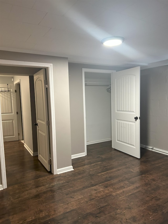 unfurnished bedroom featuring dark hardwood / wood-style flooring and a closet