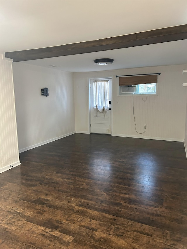 unfurnished room featuring plenty of natural light and dark wood-type flooring