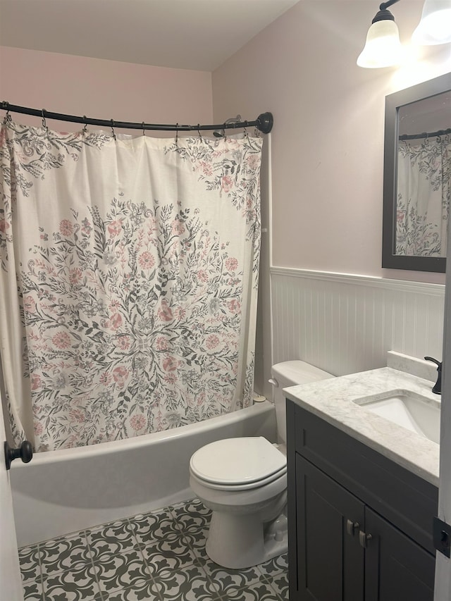 bathroom with toilet, vanity, and tile patterned floors