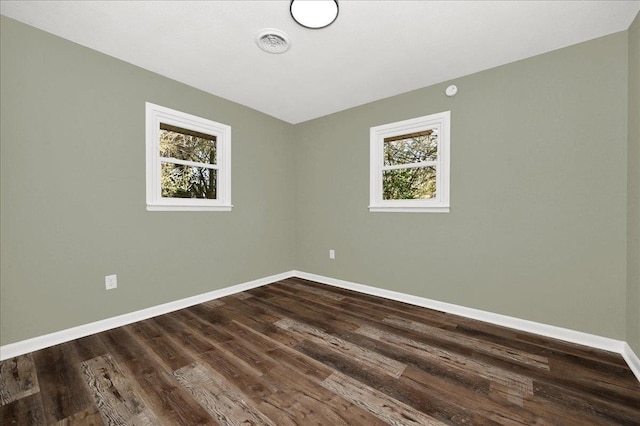 unfurnished room with dark hardwood / wood-style floors