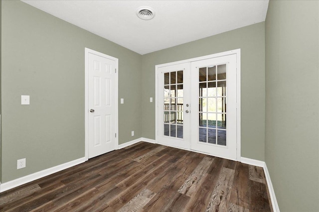 unfurnished room featuring french doors and dark hardwood / wood-style flooring