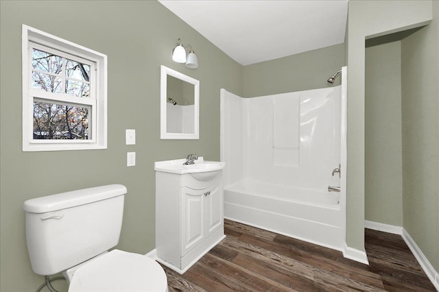 full bathroom with hardwood / wood-style floors, vanity, toilet, and shower / bath combination