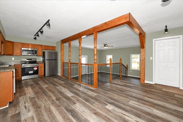 kitchen with ceiling fan, sink, dark wood-type flooring, and appliances with stainless steel finishes