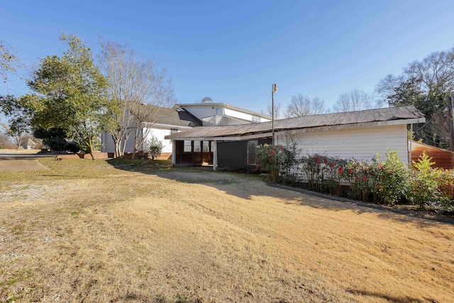 rear view of house featuring a lawn