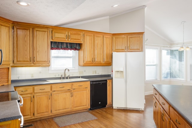 kitchen with lofted ceiling, black dishwasher, sink, and white fridge with ice dispenser