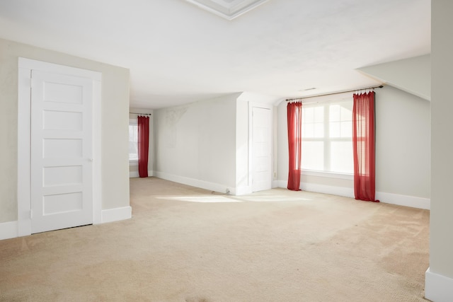 carpeted spare room featuring lofted ceiling