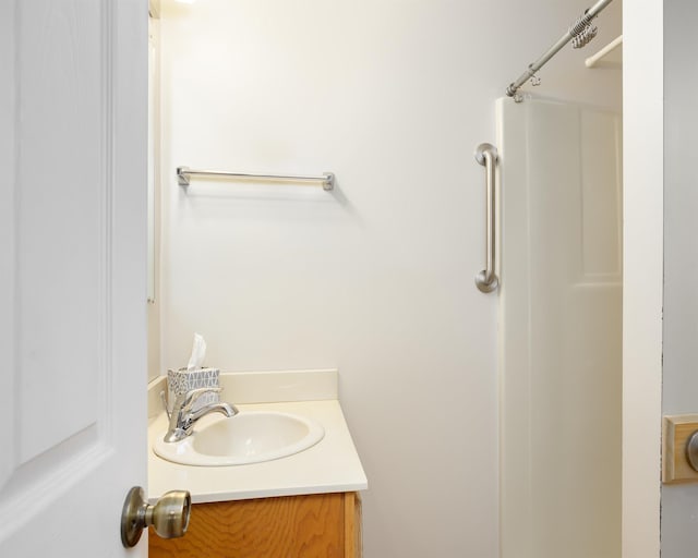 bathroom with vanity and a shower