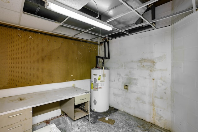 basement featuring a workshop area and water heater