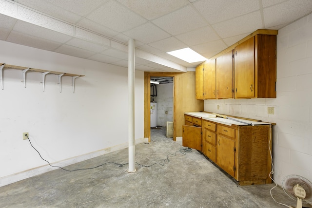 kitchen with a paneled ceiling and water heater