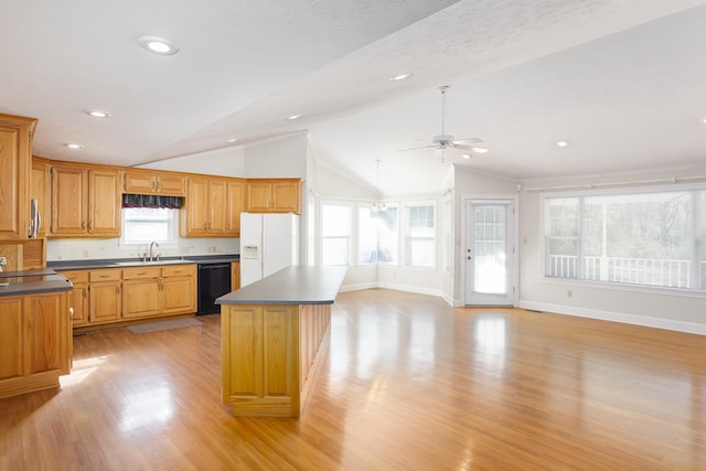 kitchen with sink, vaulted ceiling, dishwasher, a kitchen island, and white refrigerator with ice dispenser