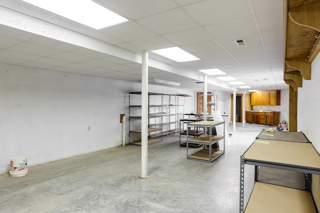 basement featuring a drop ceiling