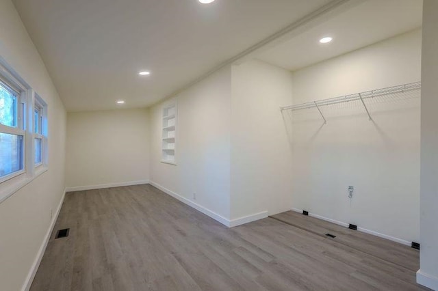 laundry room featuring light wood-type flooring