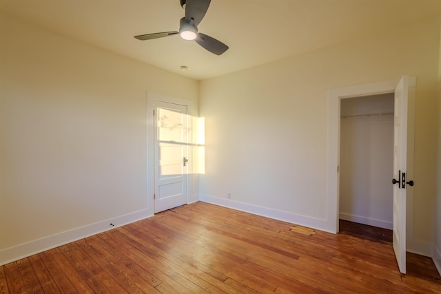 unfurnished bedroom with hardwood / wood-style flooring, a closet, and ceiling fan