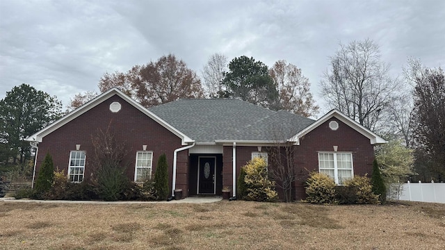 ranch-style home with a front lawn