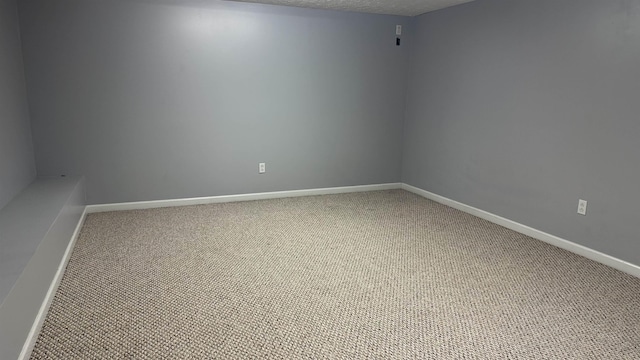 carpeted spare room featuring a textured ceiling