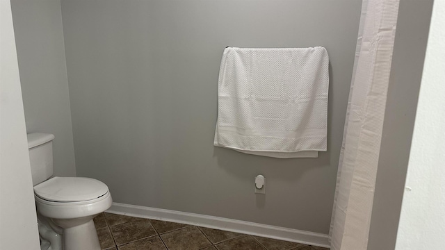 bathroom with tile patterned flooring and toilet