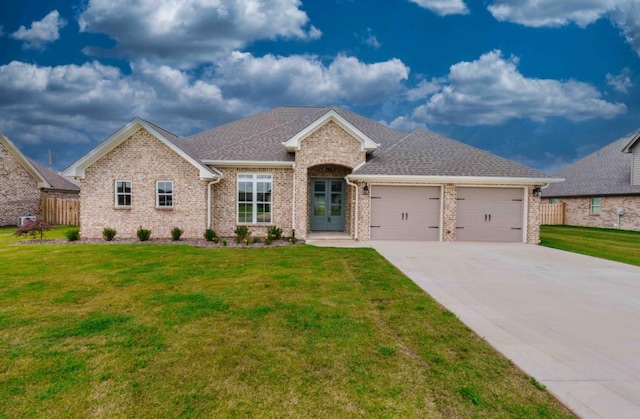 - view of front facade with a garage, brick siding, driveway, and a shingled roof