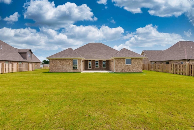  - back of property with a patio and brick siding