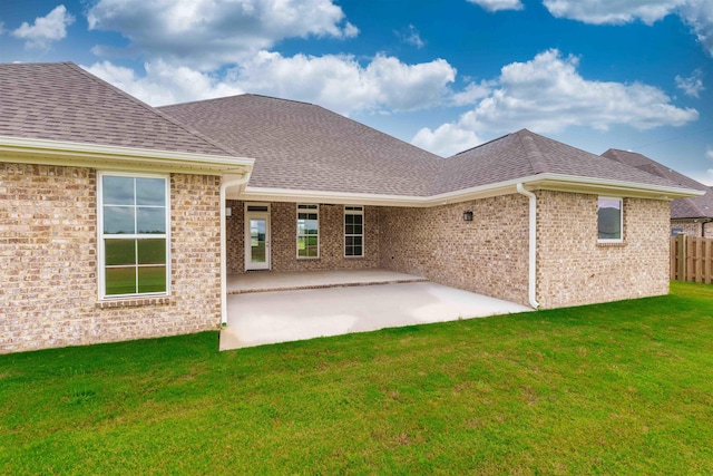  - rear view of house featuring a patio, roof with shingles, and brick siding