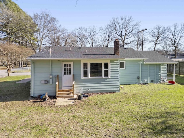 back of house with a lawn