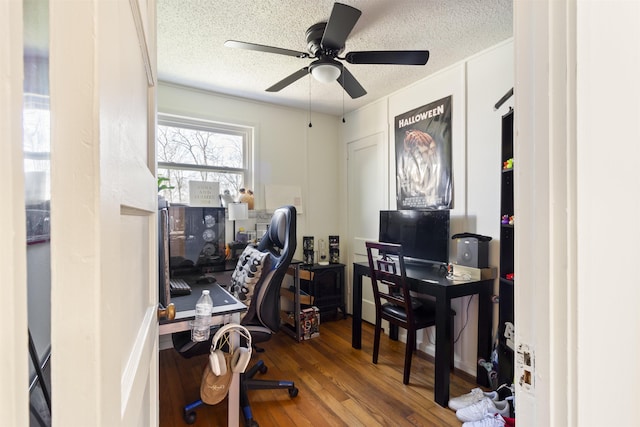 office space with hardwood / wood-style flooring, ceiling fan, and a textured ceiling