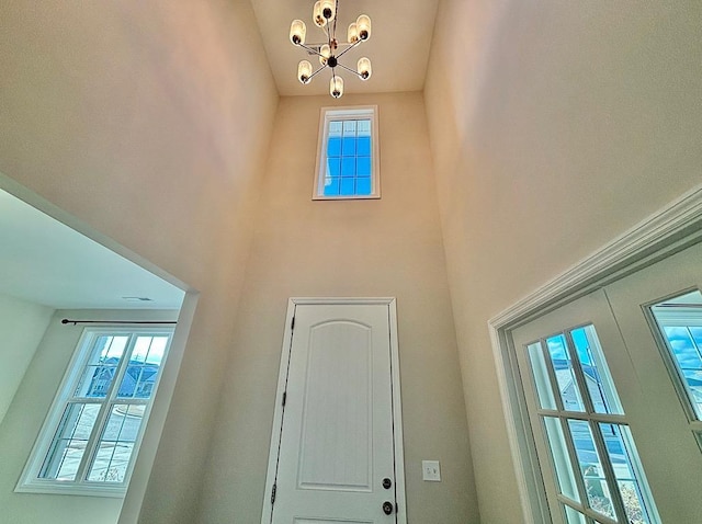 doorway with french doors and a chandelier