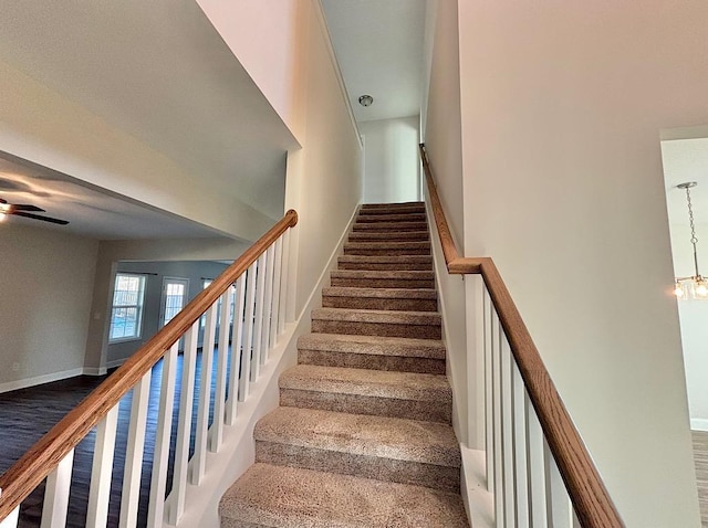 stairway featuring a chandelier