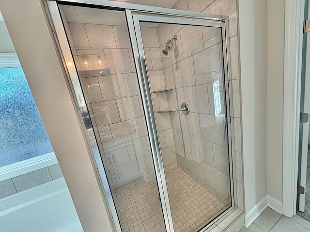 bathroom featuring a shower with door and tile patterned floors