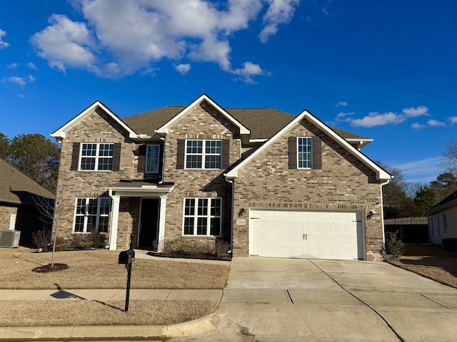 view of front of home with central AC unit and a garage