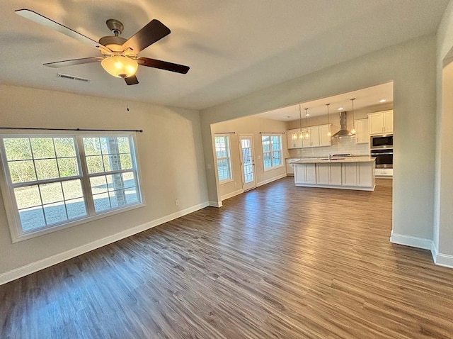 unfurnished living room featuring light hardwood / wood-style floors and ceiling fan