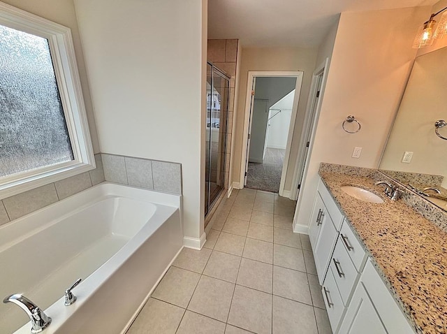 bathroom with separate shower and tub, tile patterned floors, and vanity