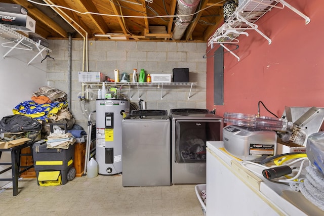  - washroom with electric water heater, washer and dryer, tile patterned floors, and concrete block wall