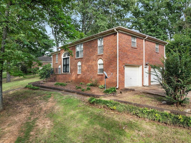  - view of side of home with a garage, brick siding, and driveway