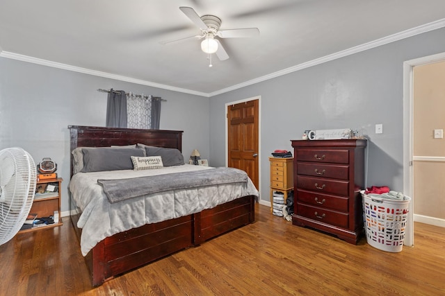  - bedroom with crown molding, wood finished floors, and a ceiling fan