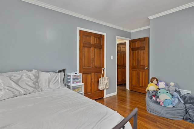  - bedroom with wood finished floors and ornamental molding