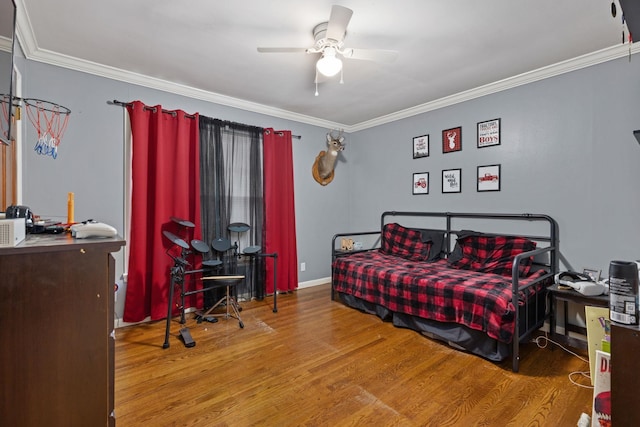  - bedroom with wood finished floors, crown molding, and ceiling fan