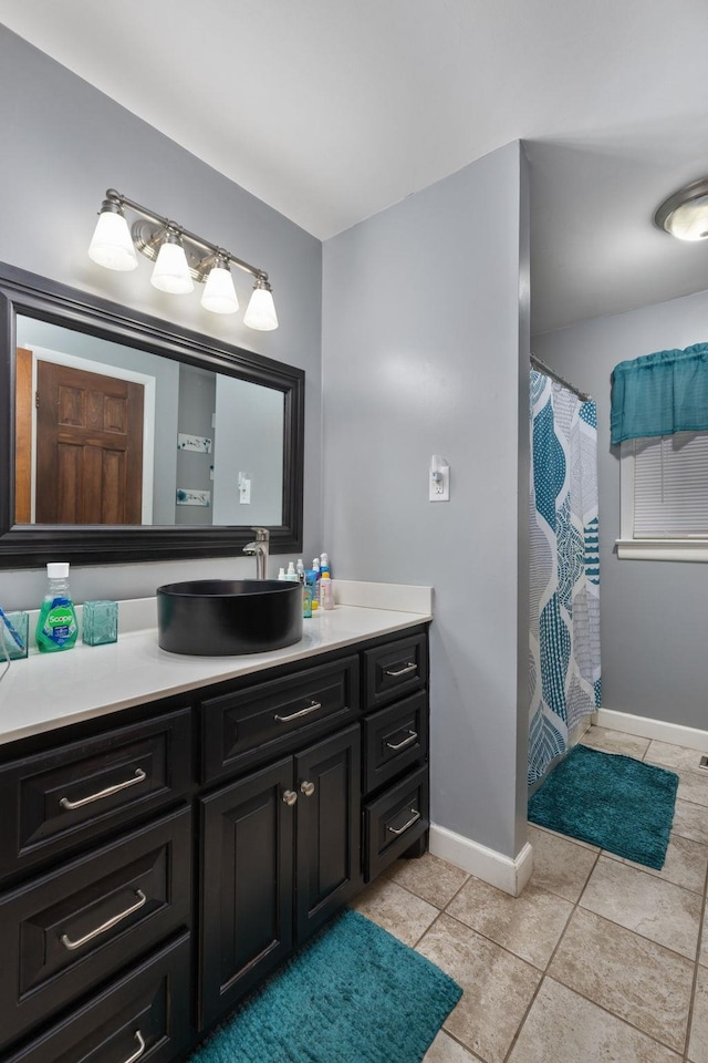  - bathroom with vanity, a shower with shower curtain, and tile patterned floors