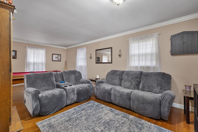  - living room featuring ornamental molding, healthy amount of natural light, and wood finished floors