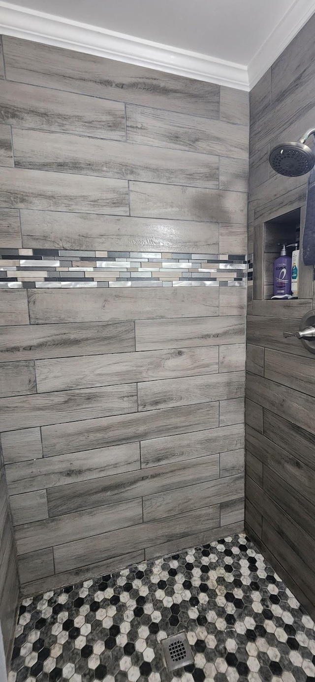  - full bathroom featuring tiled shower and ornamental molding